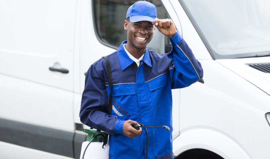 Young Smiling Worker With Pesticide Sprayer